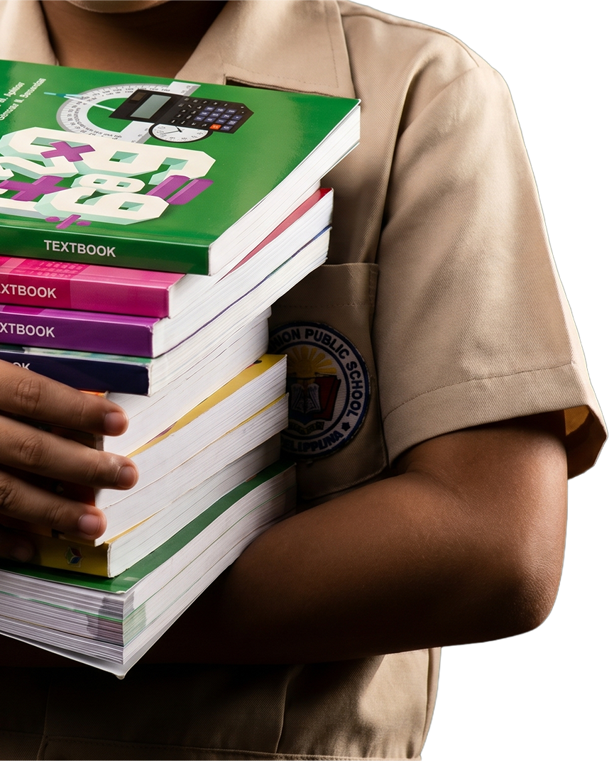 A Silid Aralan student holding a stack of textbooks